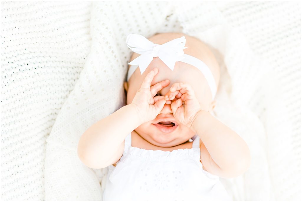 6 month old baby girl rubbing her eyes family portrait session