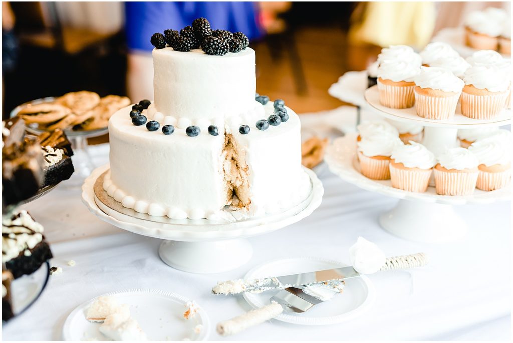 white cake with piece cut out canterbury hill winery reception