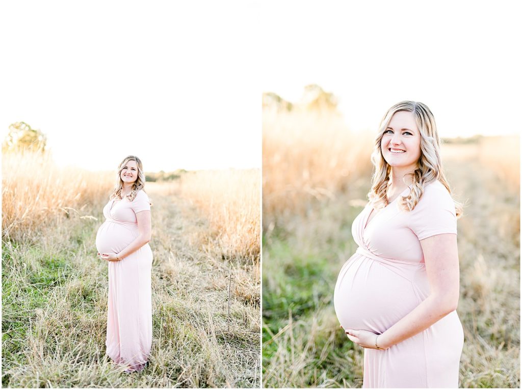 expecting mom standing in field holding baby belly long pink dress maternity session