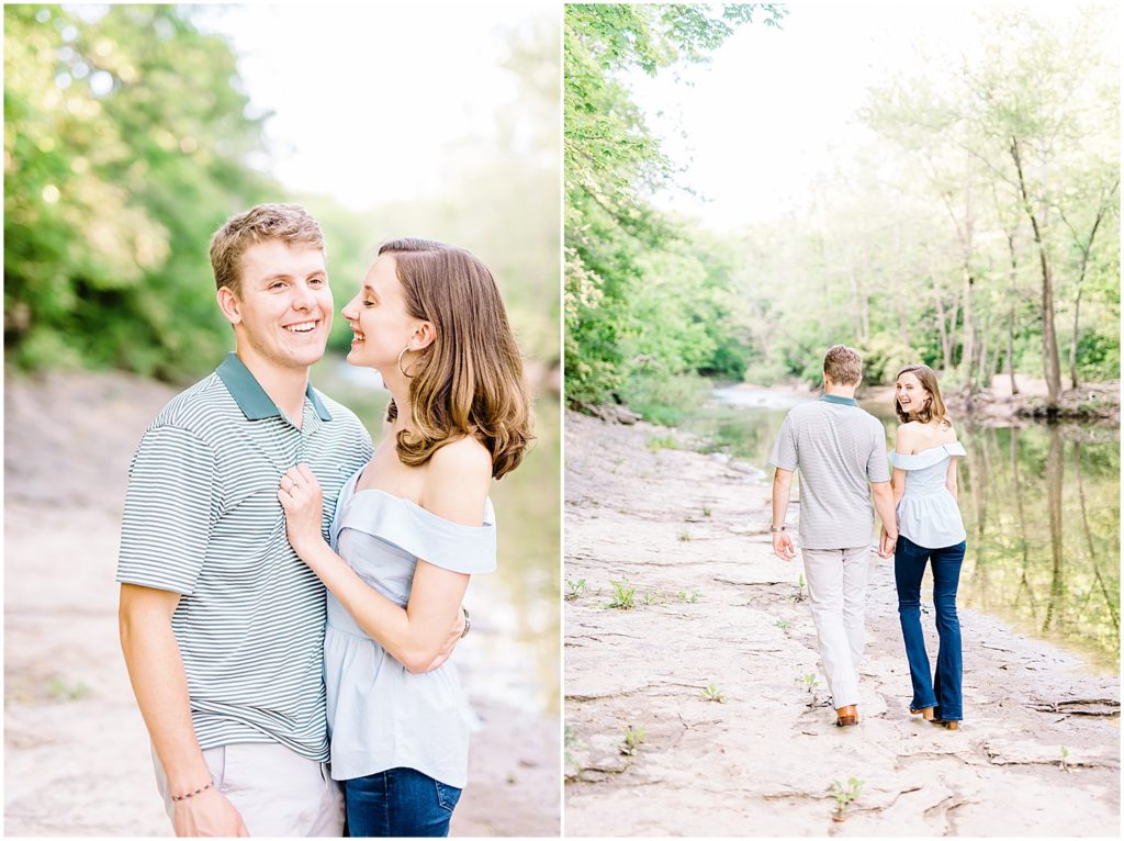 young couple smiles and laughs in creek bed for engagement pictures