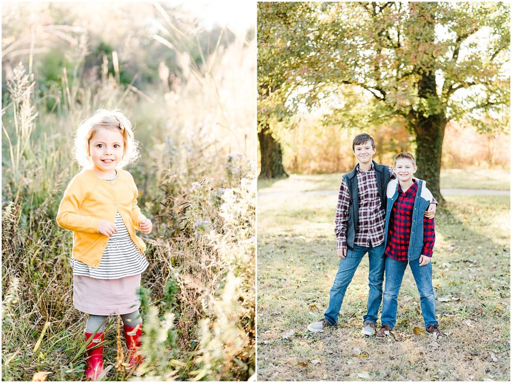 little girl wearing fall colors standing in tall grass brothers hugging wearing plaid in front of tree