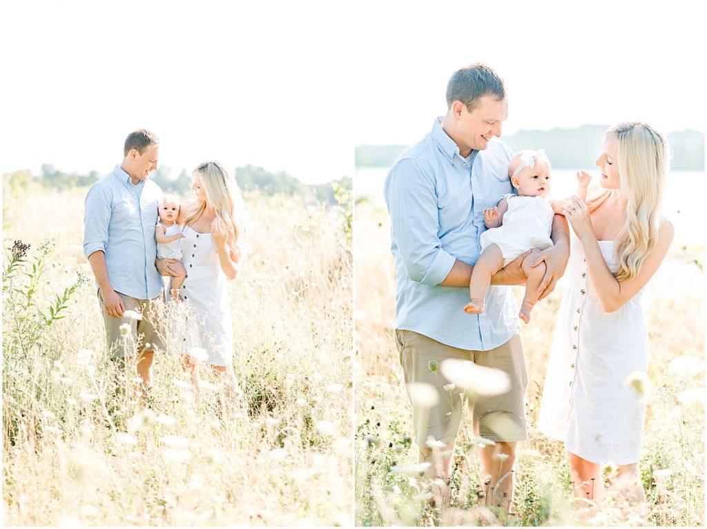 young couple holding baby girl in field family portrait session