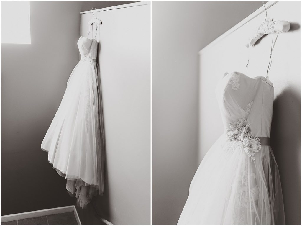 black and white wedding gown hanging on wall
