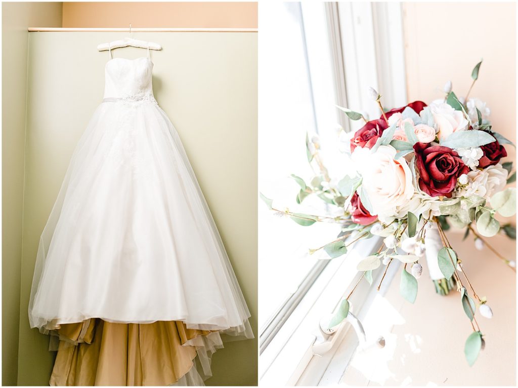traditional church wedding dress hanging on wall and bouquet in window