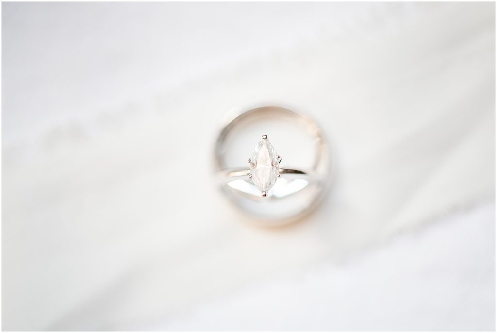 wedding ring and band up close on white background