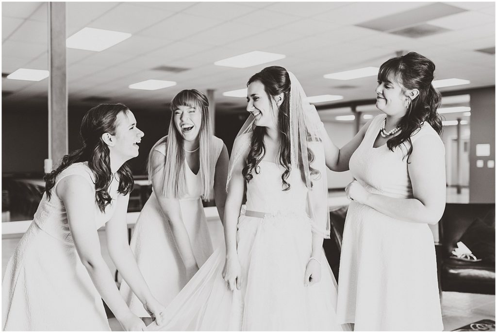 black and white bridesmaids smiling with bride