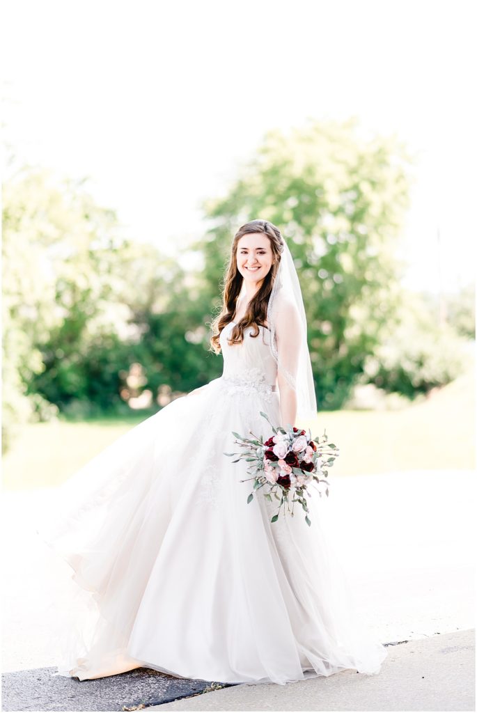 bride spinning in wedding gown with bouquet