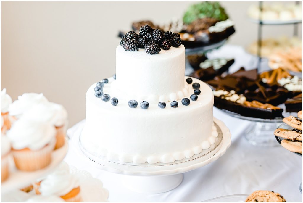 white cake with blueberries and blackberries canterbury hill winery reception