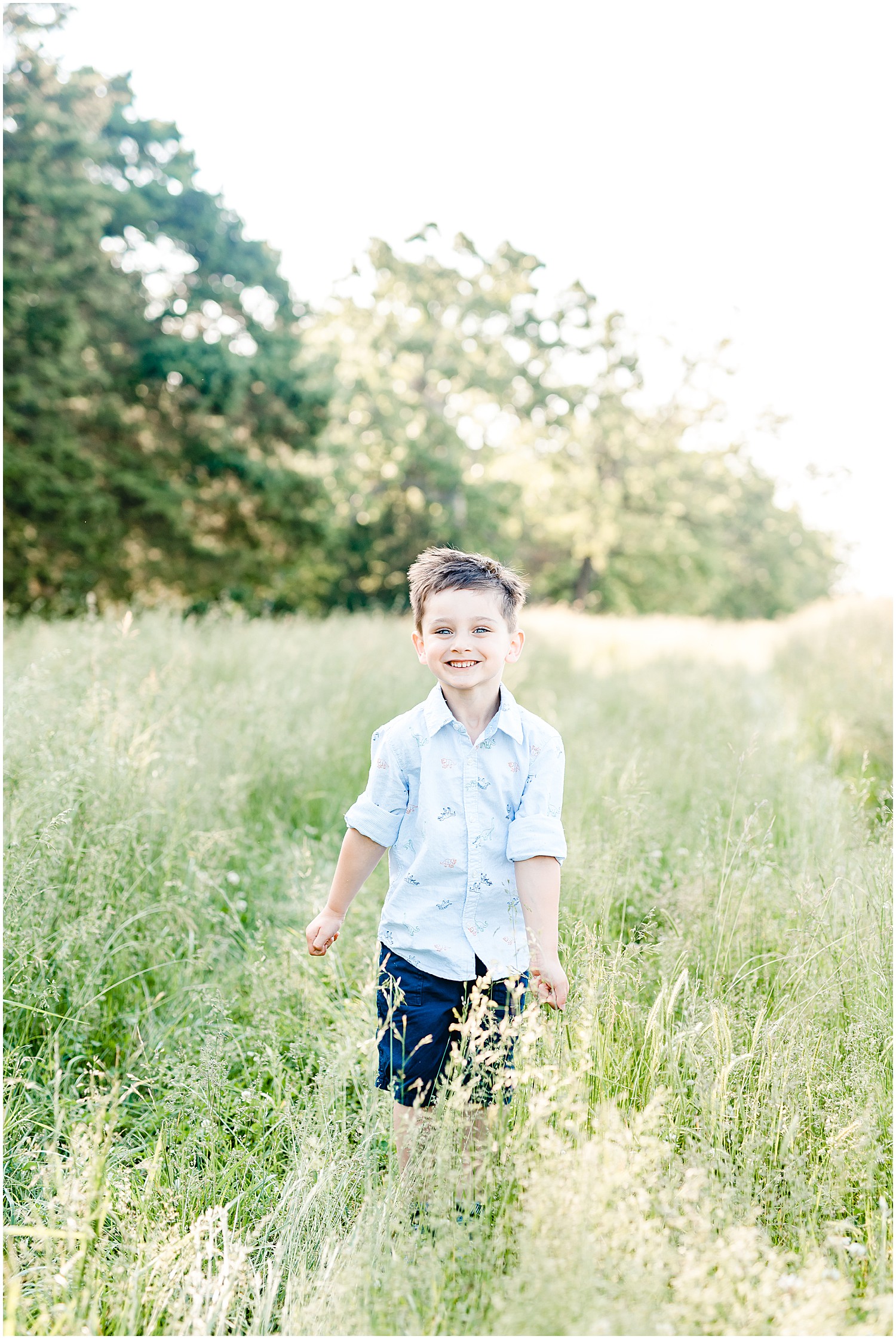 son jumping up in tall grass field Westphalia mo family session