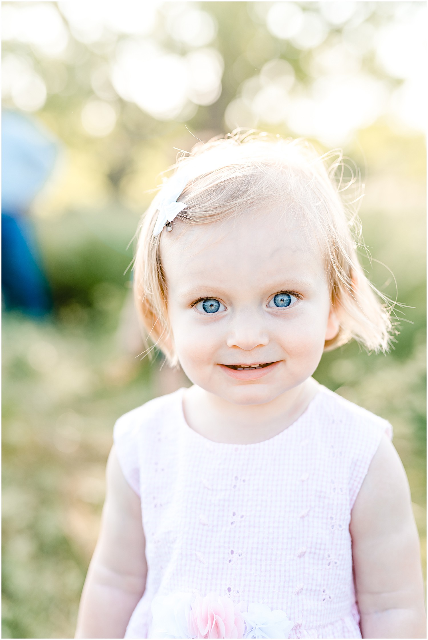 daughter bright blue eyes smiling at camera Westphalia mo family portrait session