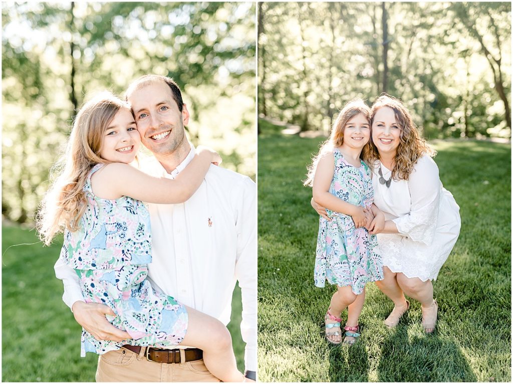 mom and dad with daughter hugging smiling family portrait session