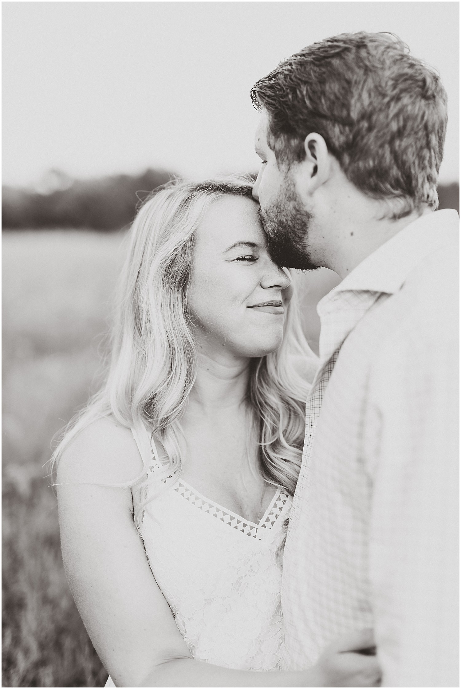 Cooper's ridge engagement session couple kissing in black and white