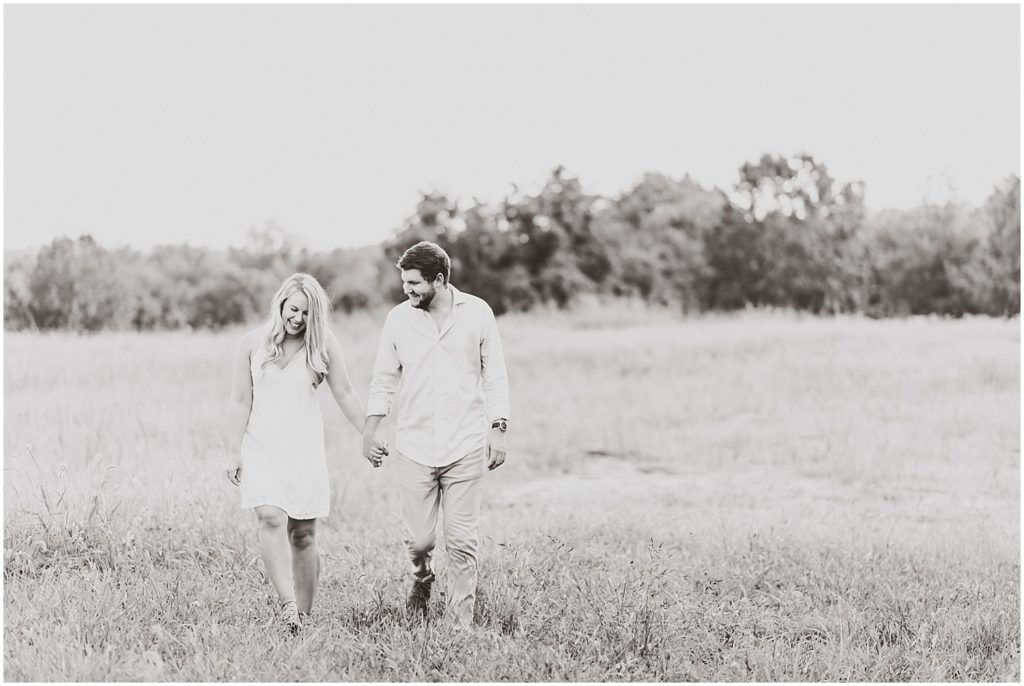 Cooper's ridge engagement session couple walking through grass black and white
