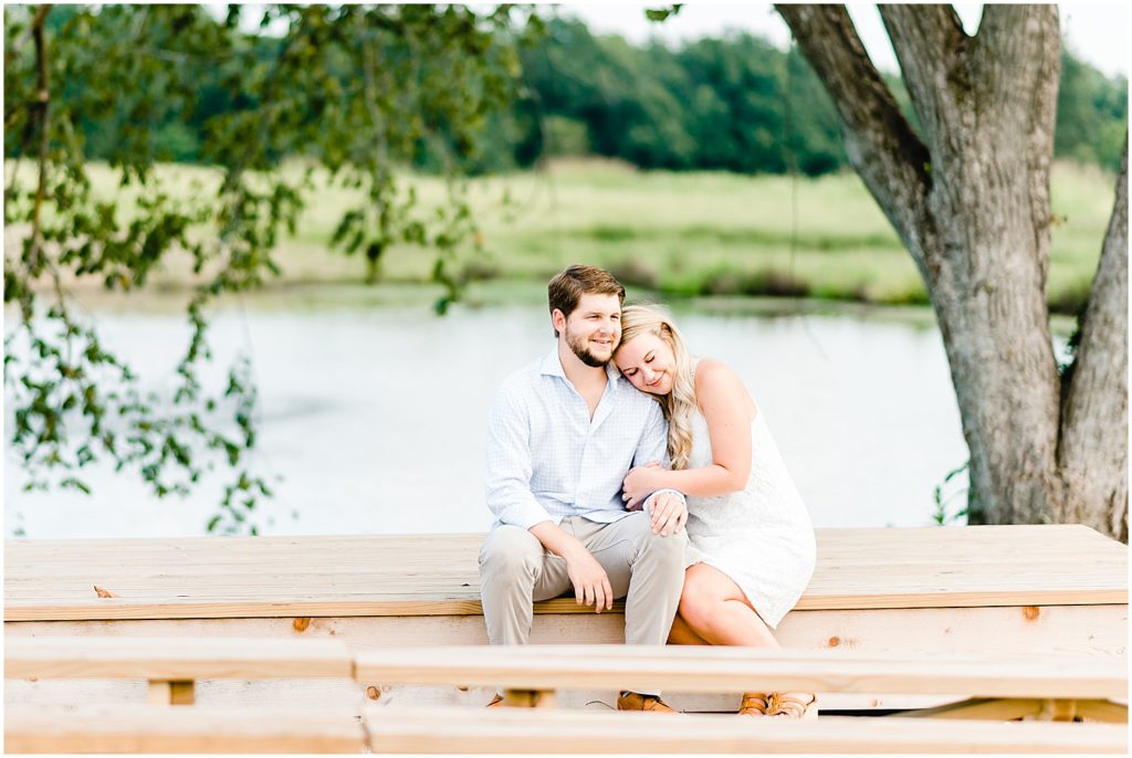 Cooper's ridge engagement session couple snuggling on a bench