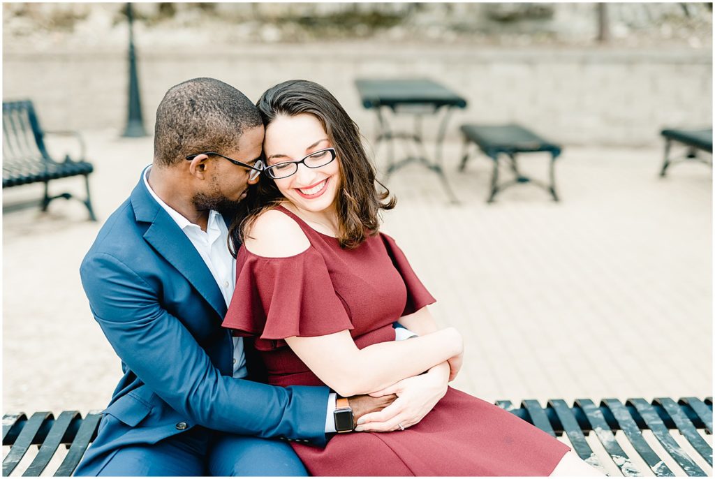 Downtown jefferson city river overlook engagement session couple snuggling on park bench