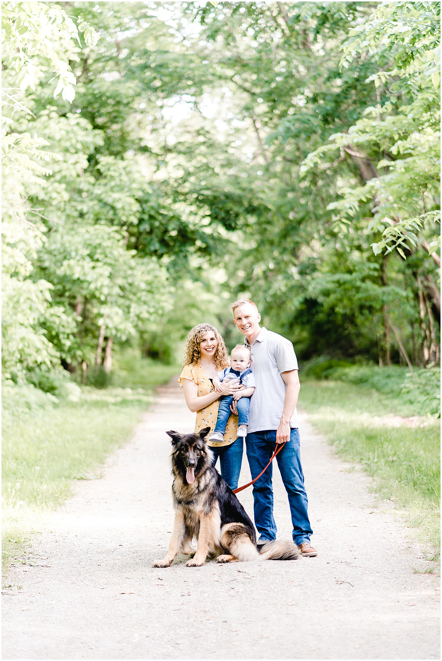 family posing together with dog on path capen park Columbia mo