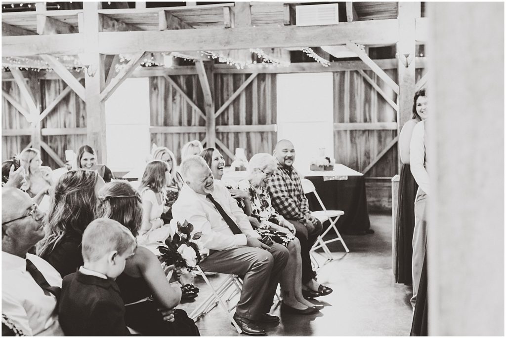 family laughing during wedding ceremony legacy barn