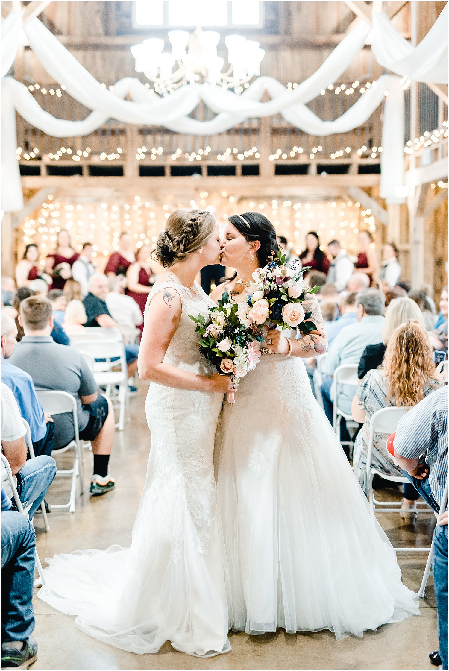 brides kissing at end of alter legacy barn wedding ceremony