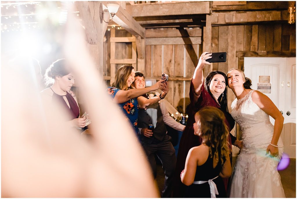 brides playing selfie game wedding reception