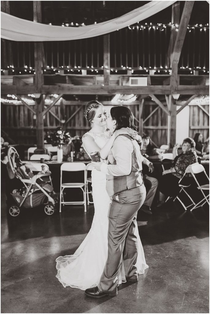 brides dancing in black and white barn wedding