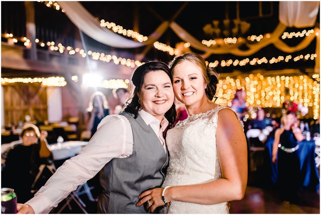 brides smiling at camera legacy barn wedding reception