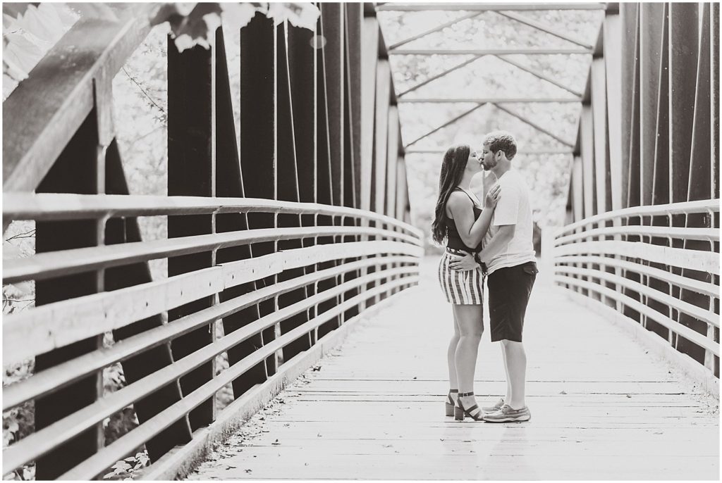 capen park engagement session couple on bridge black and white