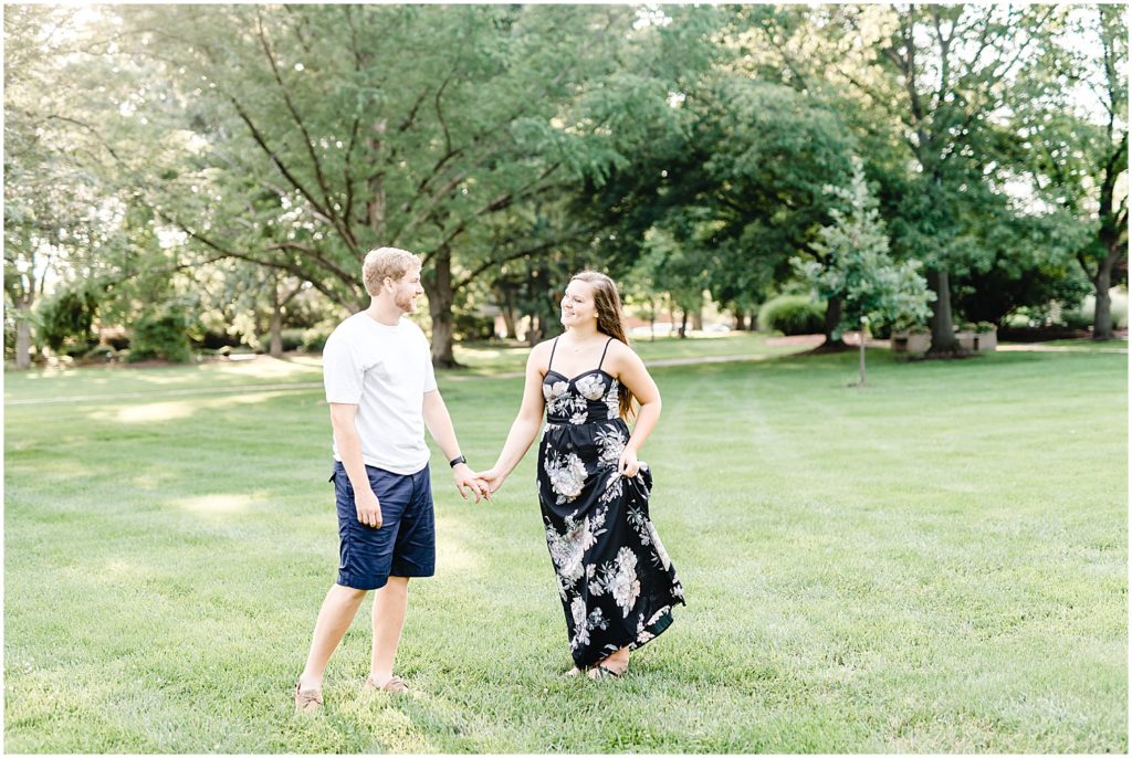 shelter gardens engagement session couple walking on grass