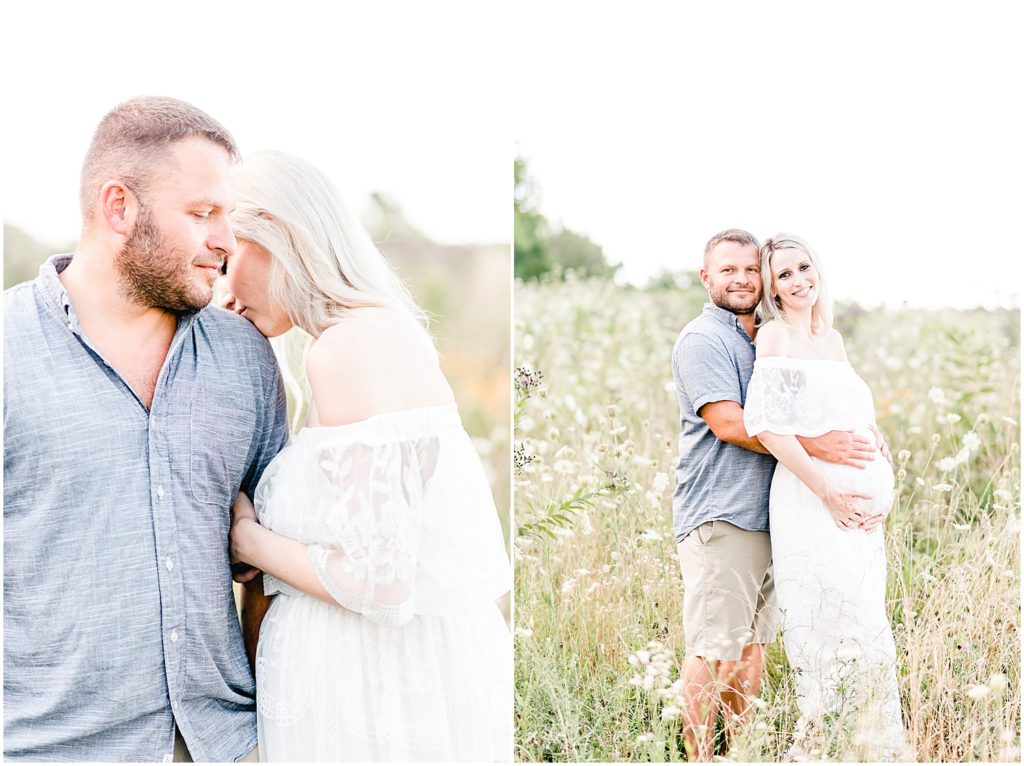 pregnant mom and dad snuggling in wildflower field