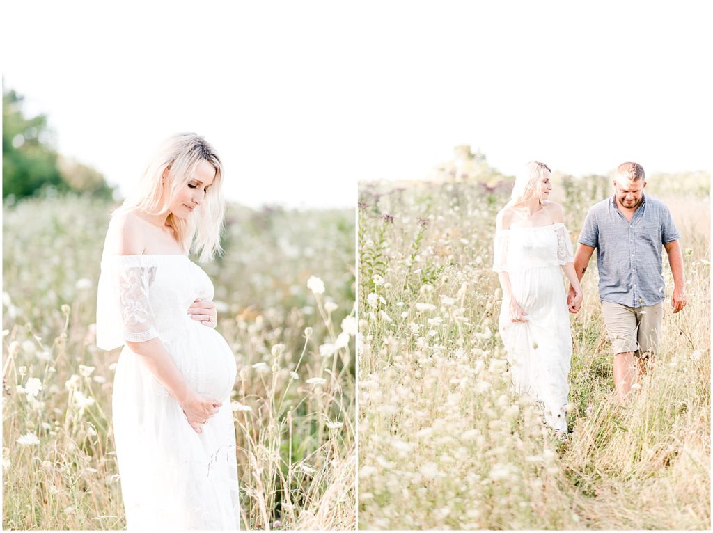 pregnant mom holding belly in long white dress mom and dad walking through field
