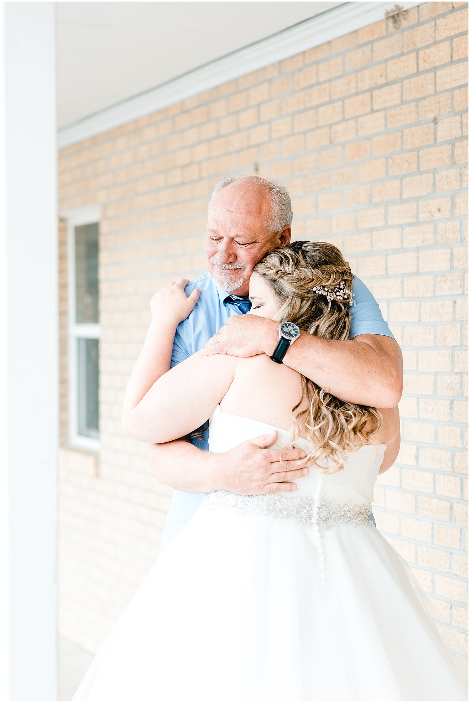 first look with dad hugging bride outside of church