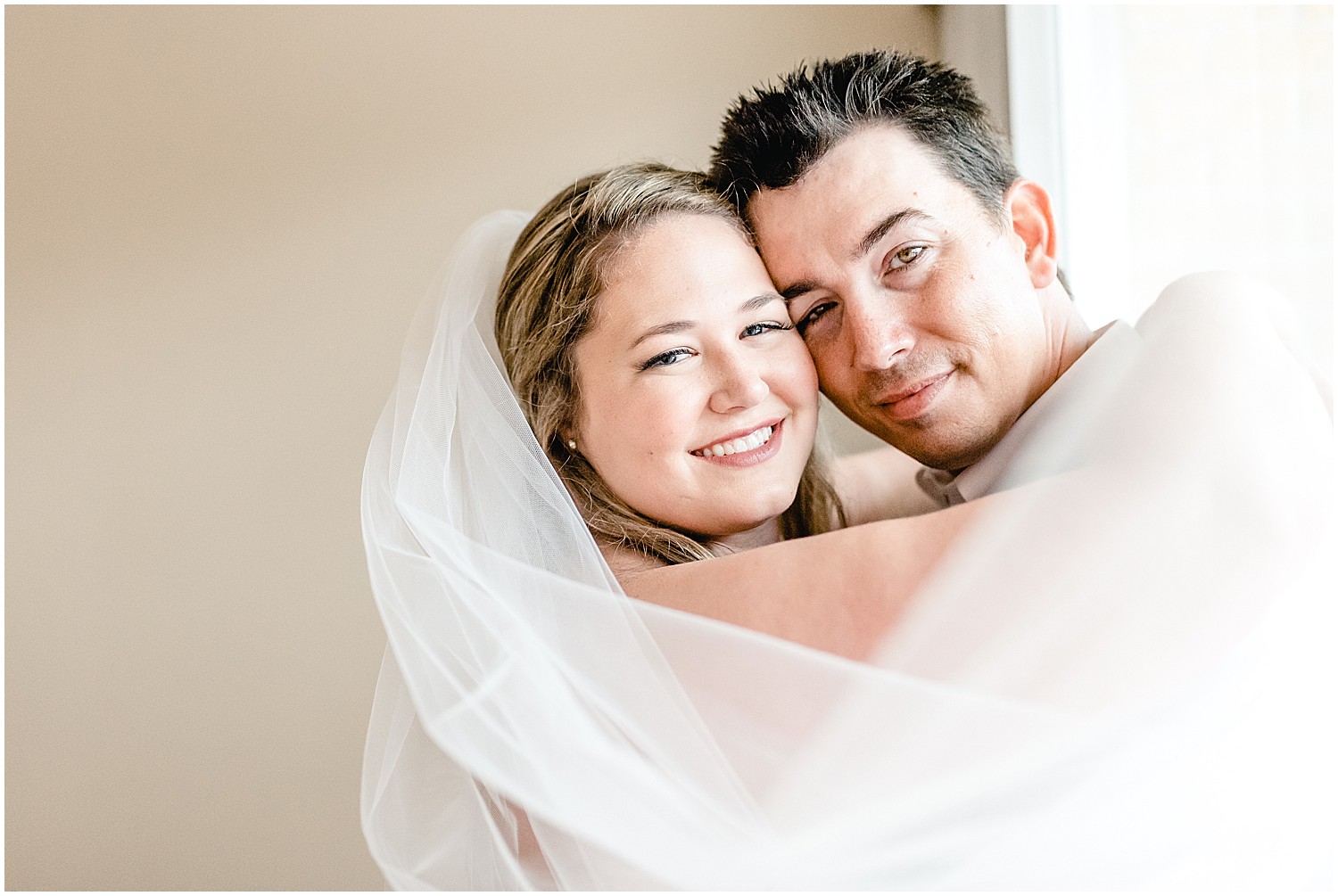 bridal and groom portraits by window