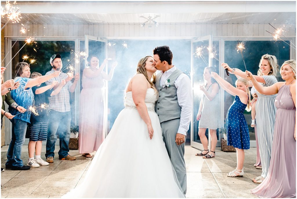 bride and groom kissing sparkler exit eldon mo church 