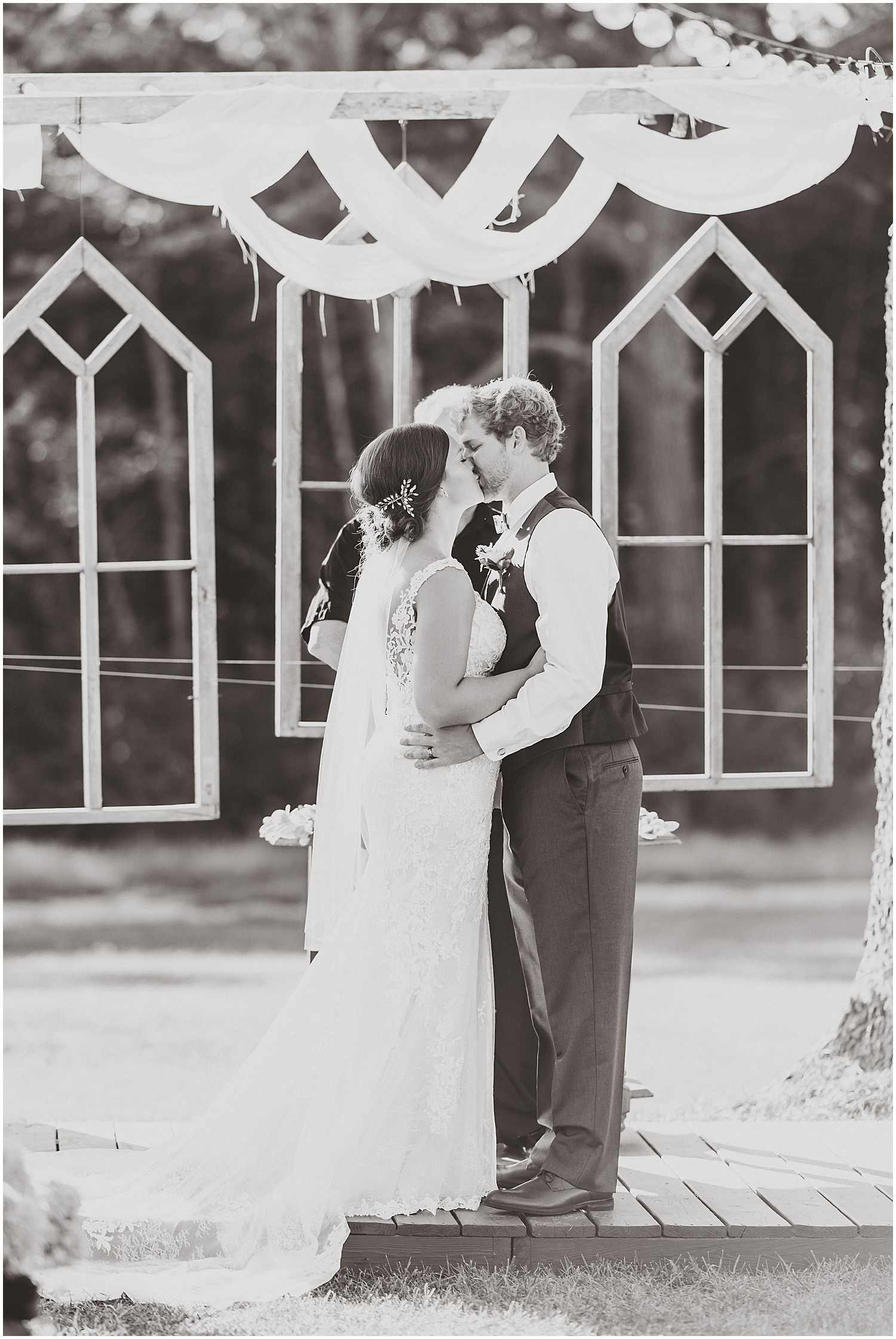 first kiss black and white at the altar barn at honeysuckle farms wedding