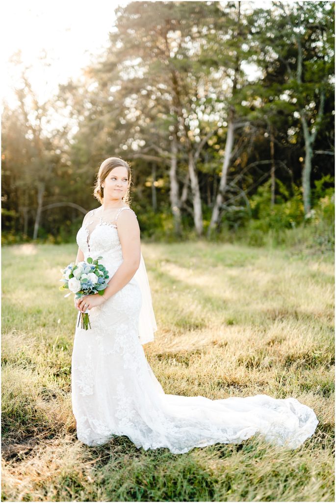 bridal portraits in grass sunlight barn at honeysuckle farms wedding