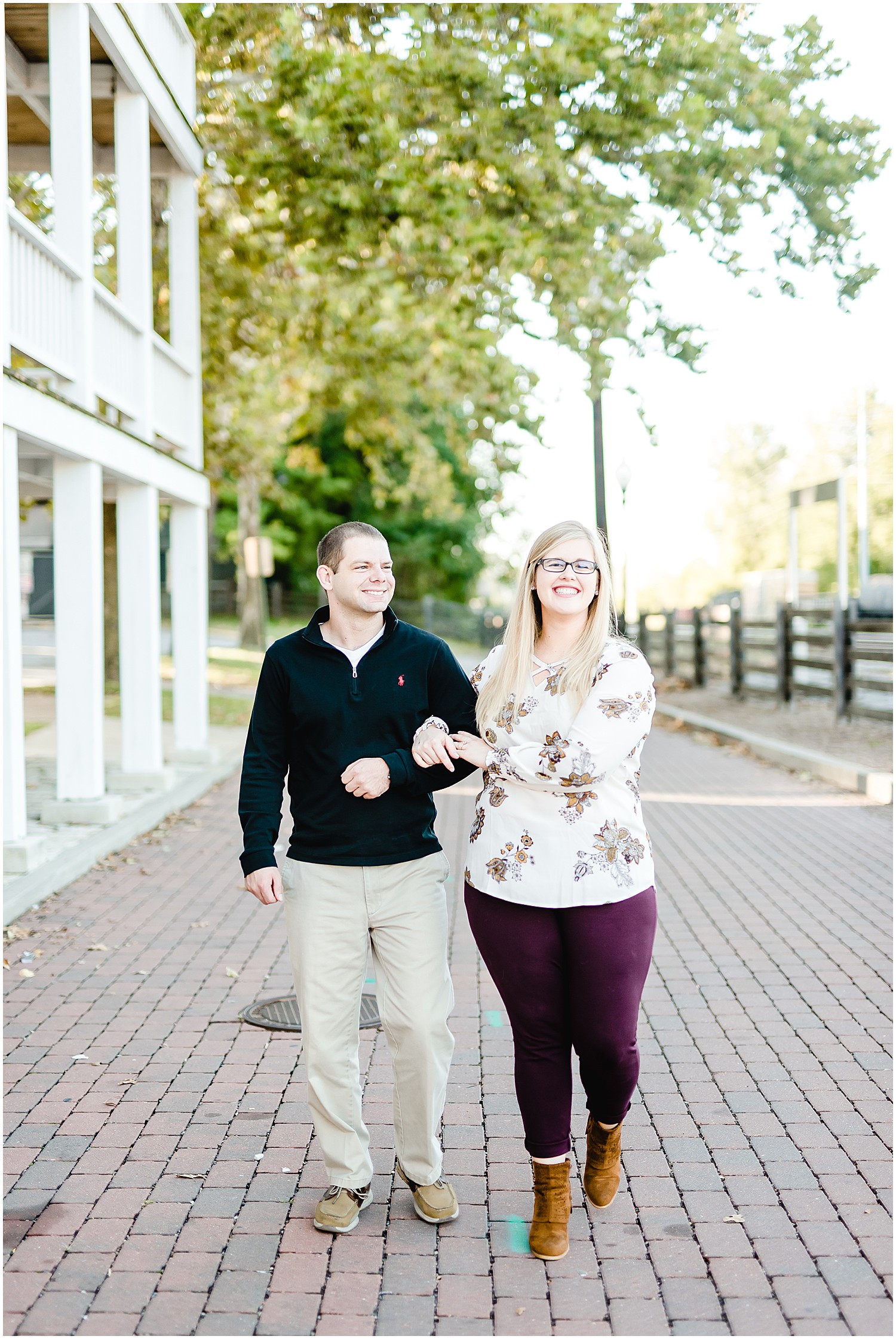couple walking smiling engagement session downtown jefferson city mo