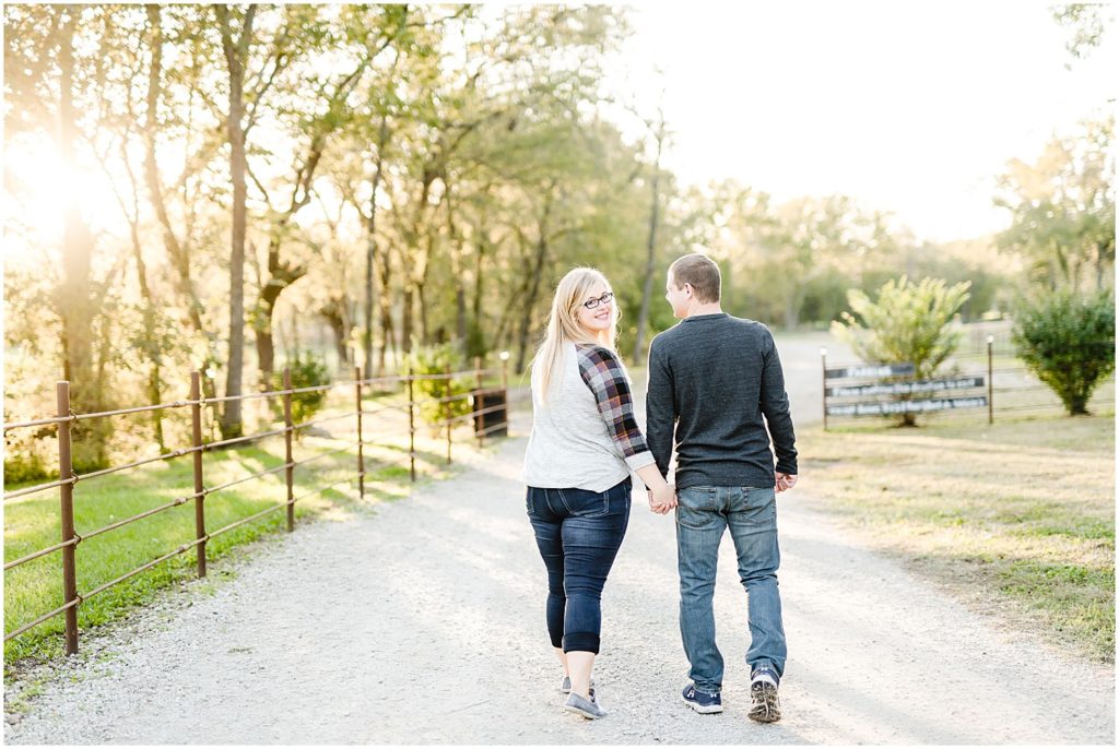 couple walking away smiling at camera kempker's back 40 engagement session