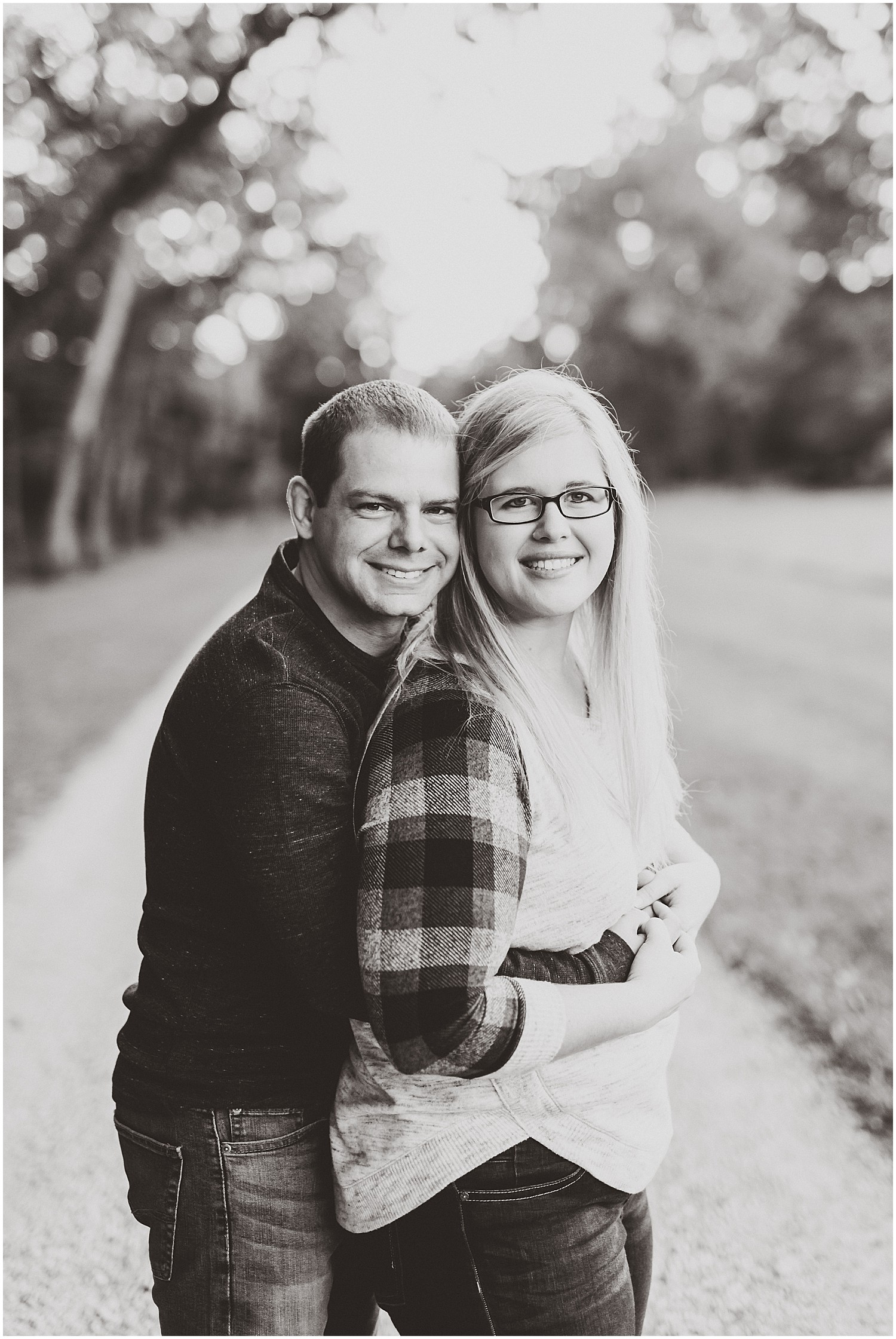 couple smiling at camera engagement session black and white