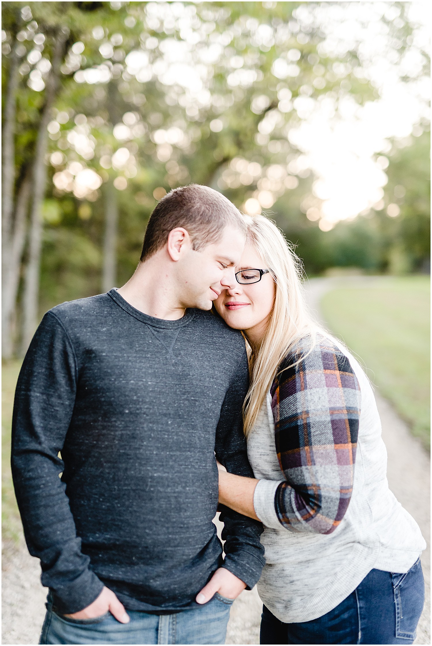 couple snuggling smiling engagement session