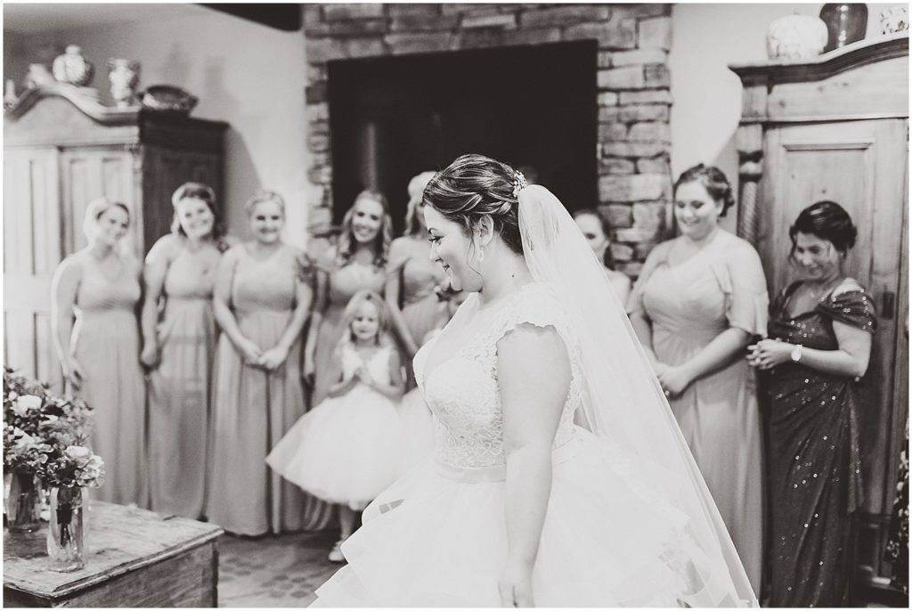 black and white bride revealing dress to bridesmaids