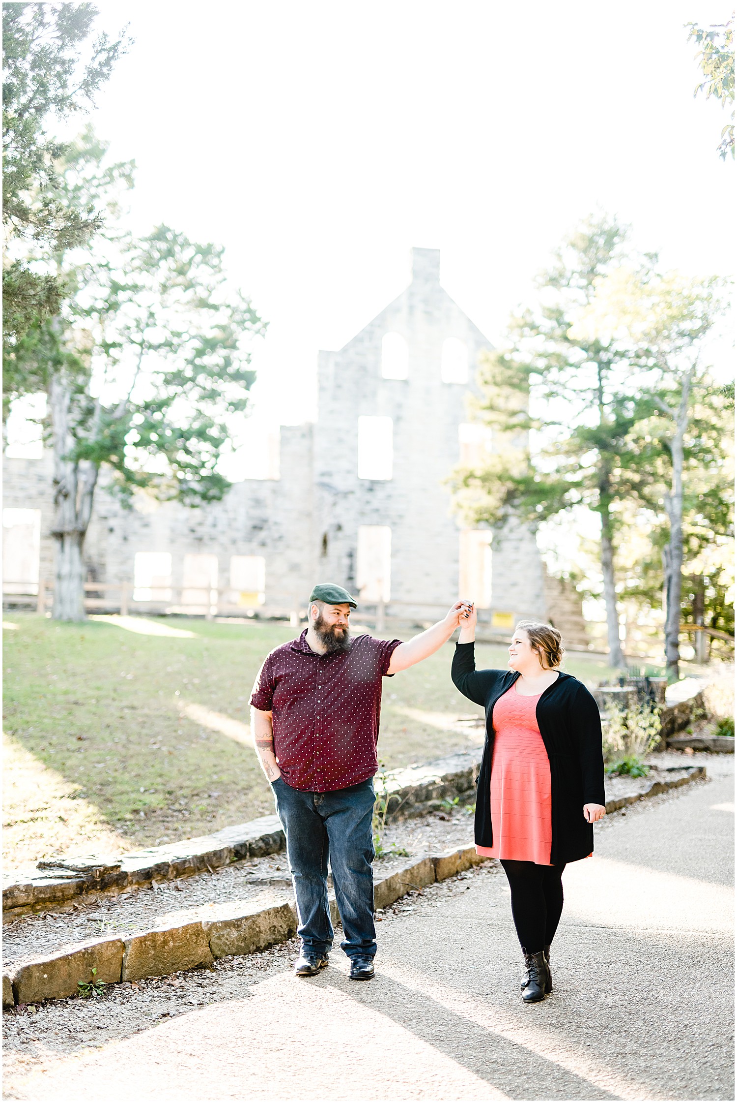 couple dancing on path castle ruins in background ha ha tonka engagement session