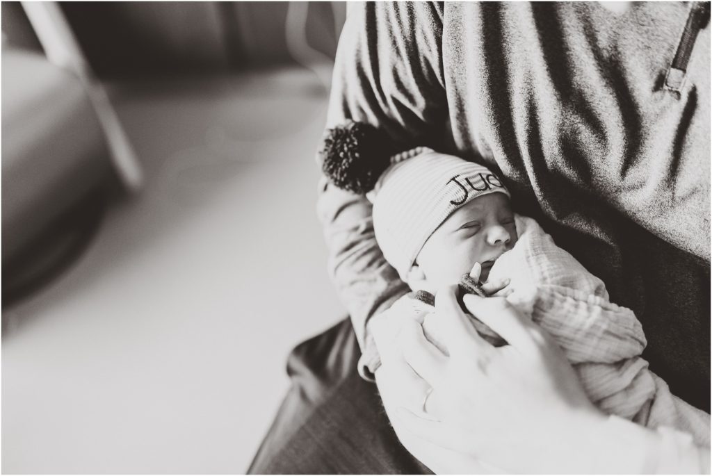 black and white of dad holding newborn baby fresh 48