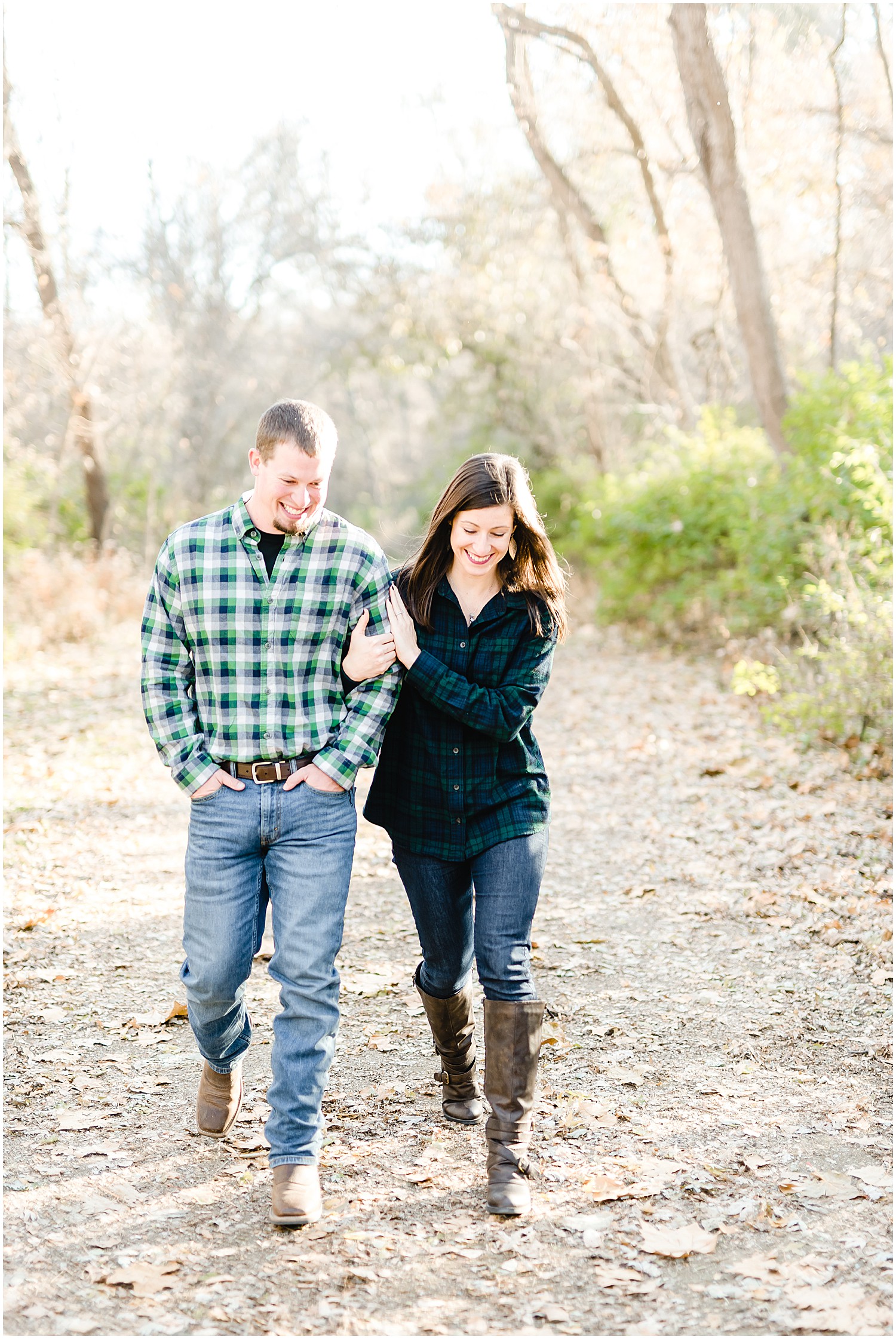 couple walking on trail smiling capen park engagement session