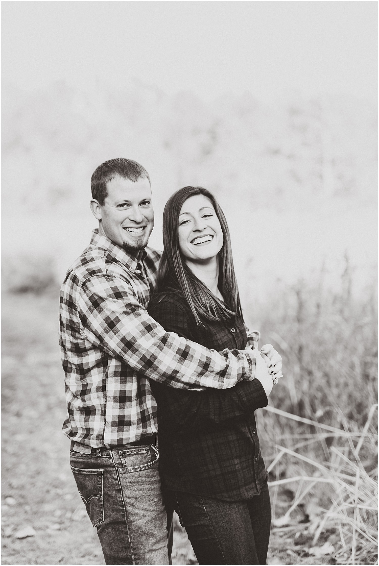 black and white couple smiling at camera engagement session