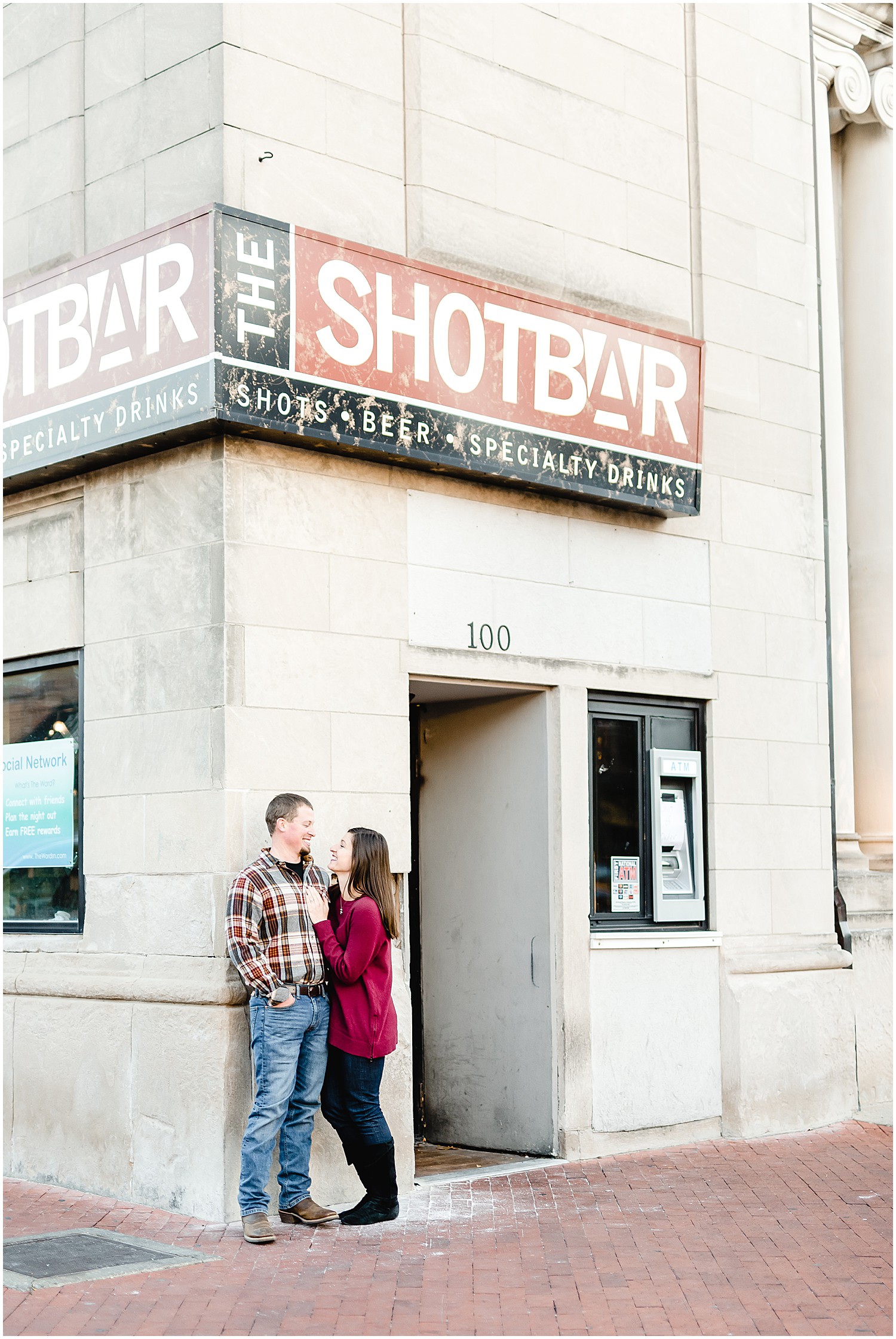couple smiling outside of bar downtown columbia mo engagement session
