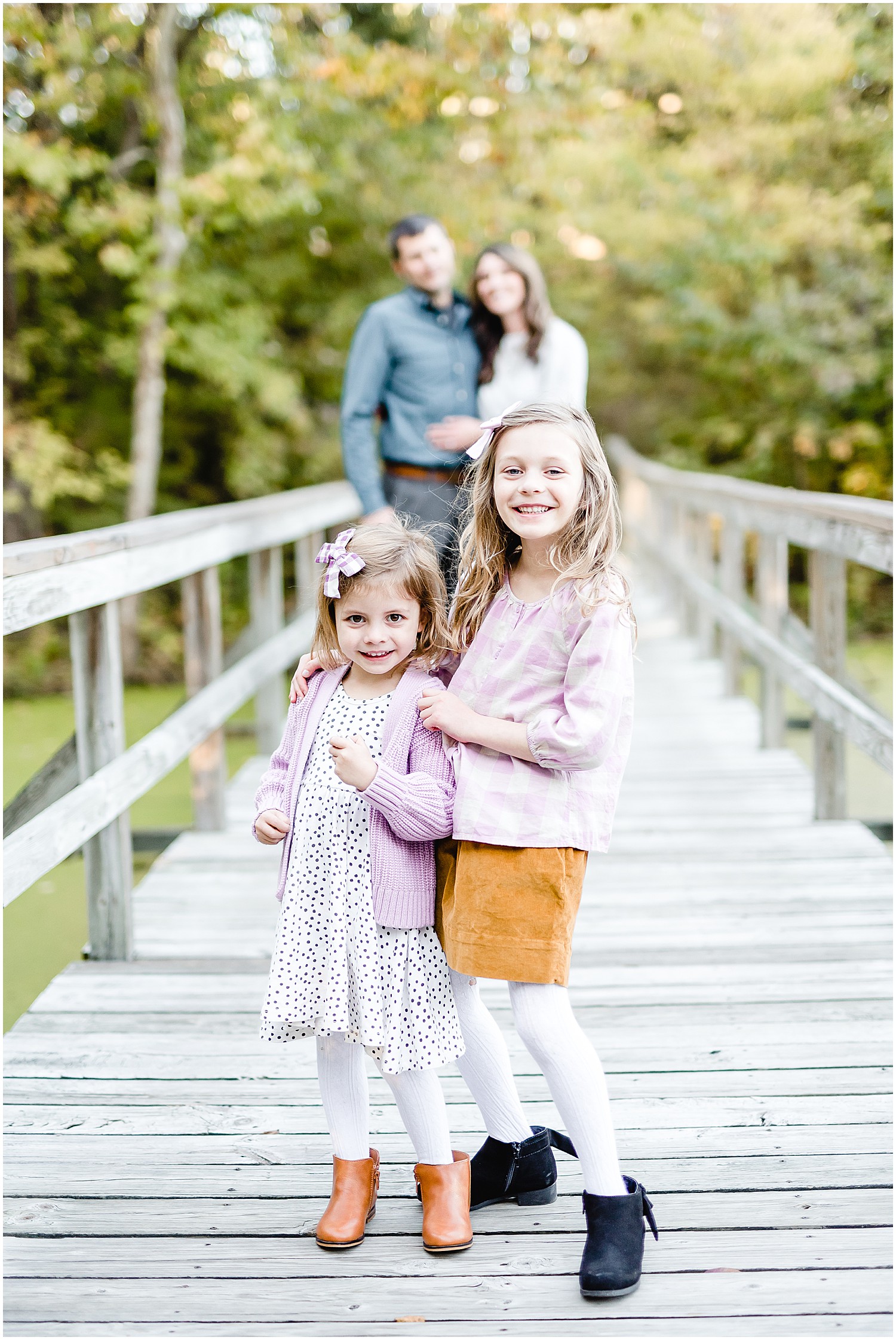 family posing on bridge runge nature center