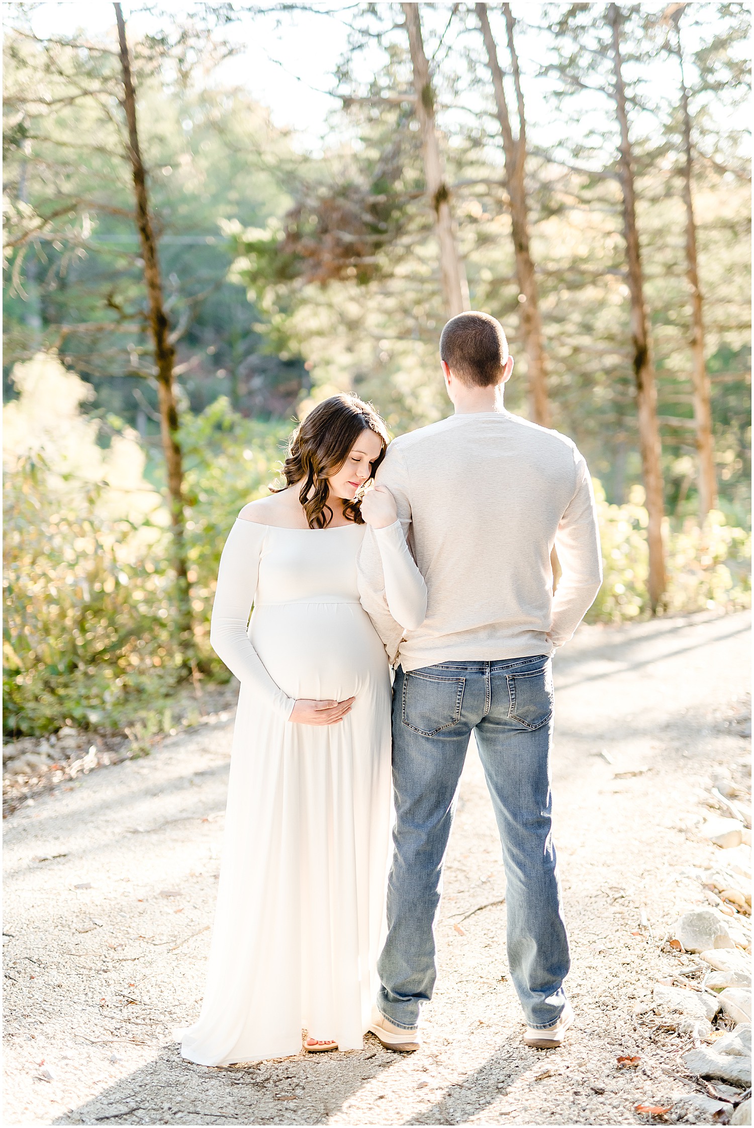 expecting couple holding each other fall maternity session
