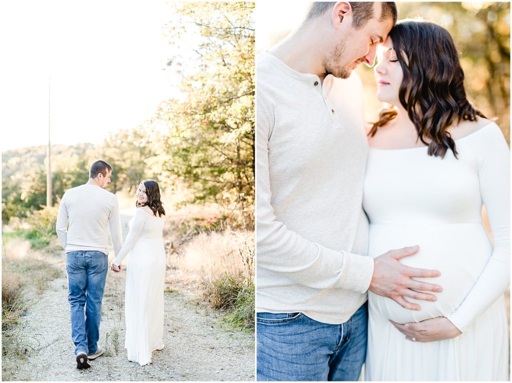 couple holding baby belly walking on path sunlight fall maternity session