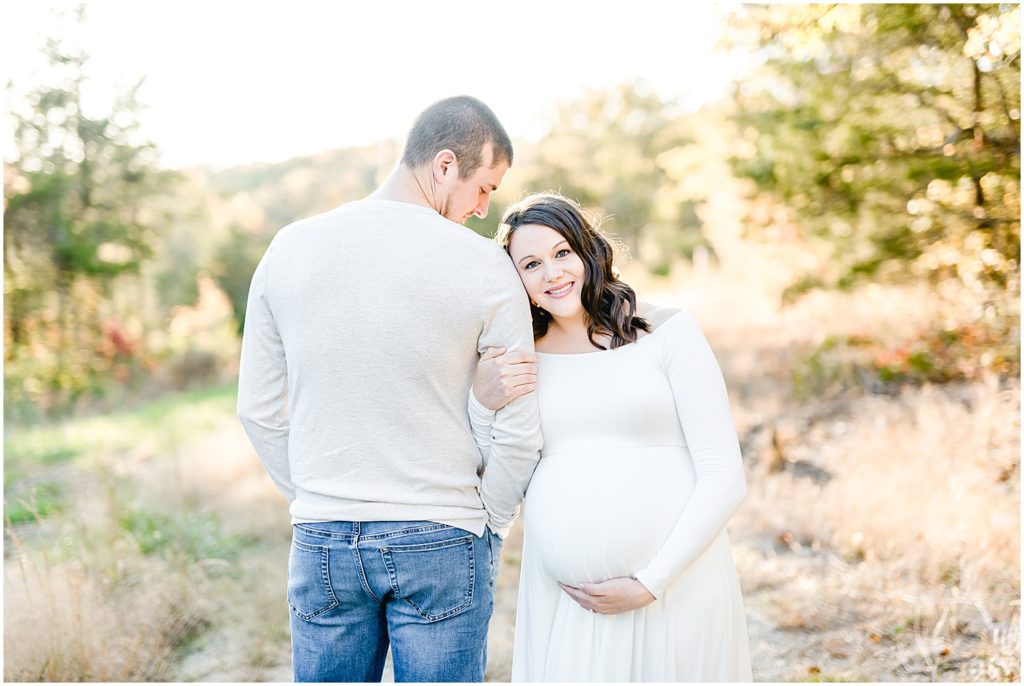 couple holding baby belly fall maternity session