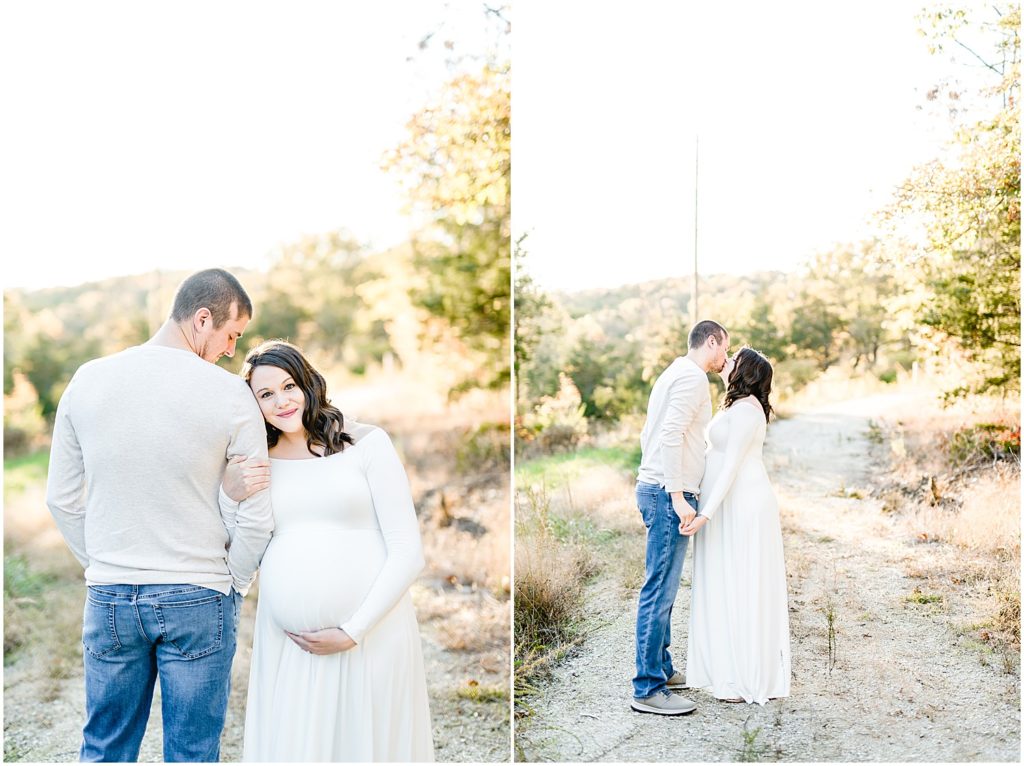 couple kissing on path holding baby belly