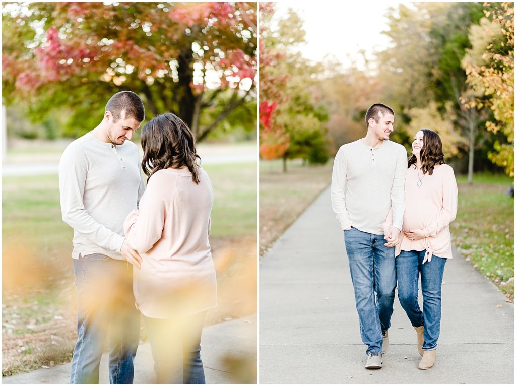 expecting couple walking together looking at baby belly